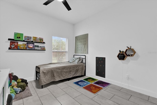 tiled bedroom featuring ceiling fan