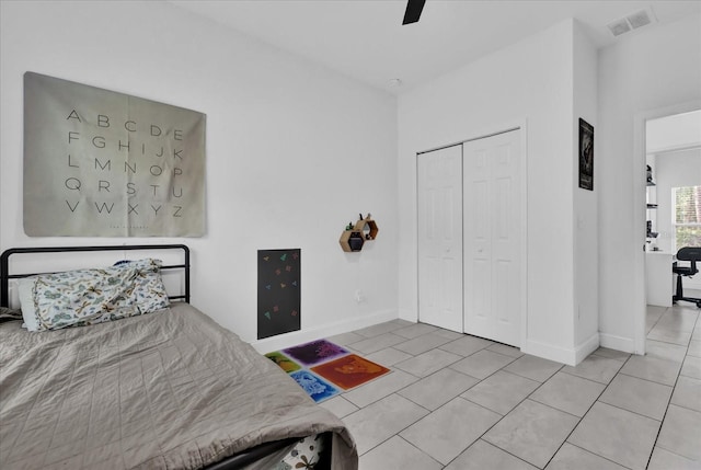 tiled bedroom with a closet and ceiling fan