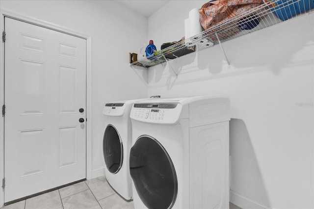 laundry area with separate washer and dryer and light tile patterned flooring