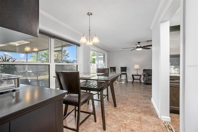 dining room featuring ceiling fan with notable chandelier and crown molding