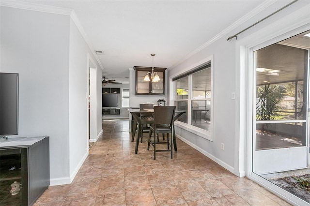 dining room featuring ceiling fan with notable chandelier and crown molding