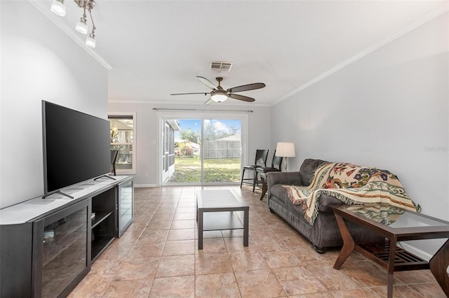 living room with ceiling fan, ornamental molding, and light tile patterned floors