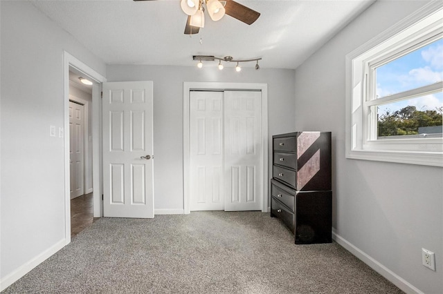 carpeted bedroom with a closet and ceiling fan