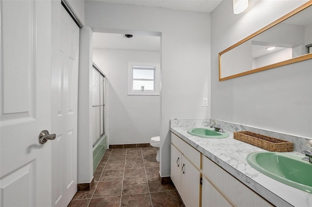 full bathroom with vanity, enclosed tub / shower combo, and toilet