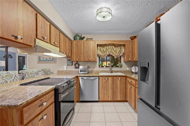 kitchen featuring kitchen peninsula, a textured ceiling, stainless steel appliances, sink, and light tile patterned floors