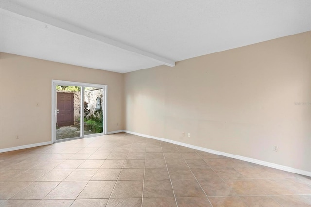 empty room featuring beam ceiling and light tile patterned floors