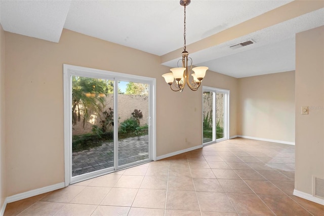 unfurnished dining area with a healthy amount of sunlight, light tile patterned flooring, and an inviting chandelier