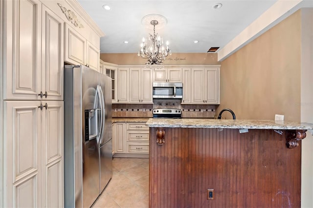 kitchen featuring light stone countertops, backsplash, stainless steel appliances, a breakfast bar area, and light tile patterned flooring