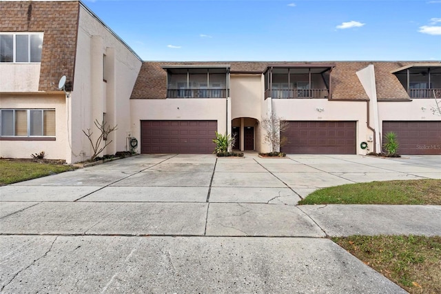 townhome / multi-family property with a balcony and a garage