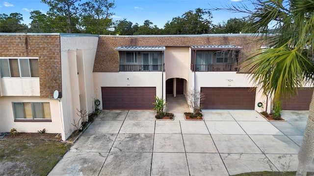 multi unit property featuring a garage and a balcony