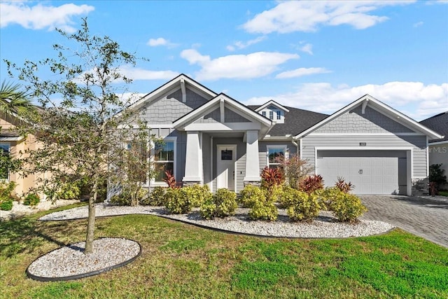 craftsman house with a front lawn and a garage