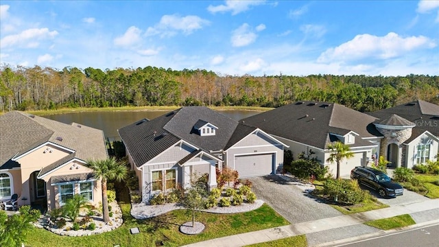 view of front of house featuring a garage and a water view