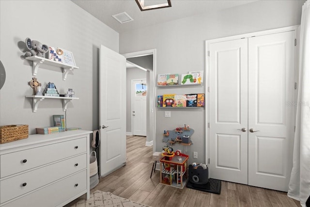 bedroom with a closet and light hardwood / wood-style flooring