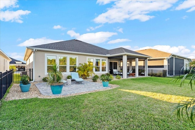 back of house featuring a patio and a lawn