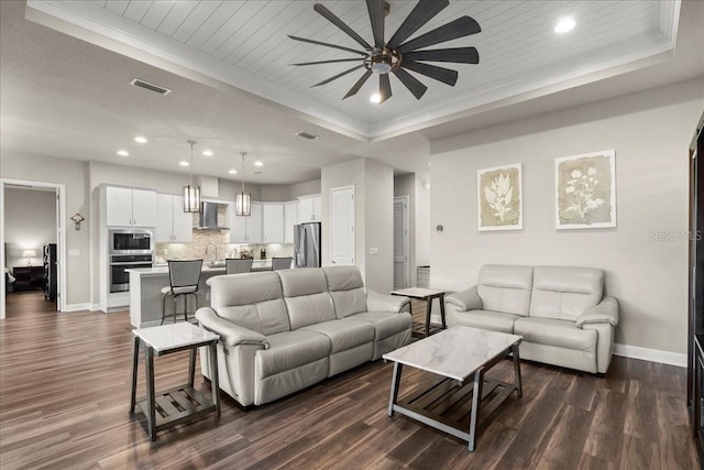 living room featuring wood ceiling, a tray ceiling, ceiling fan, sink, and dark hardwood / wood-style floors