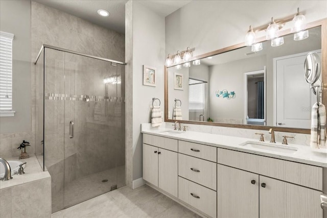 bathroom with tile patterned flooring, vanity, and shower with separate bathtub