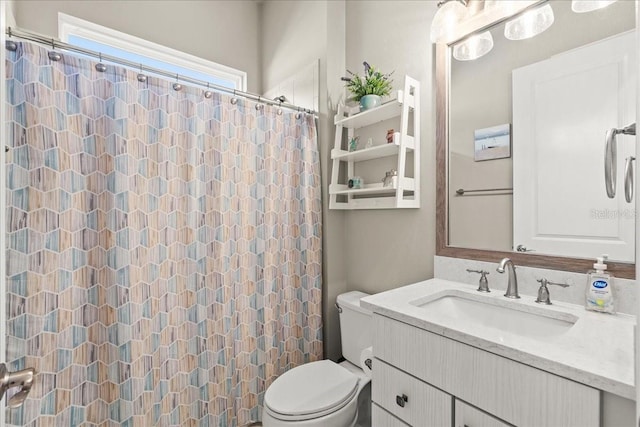 bathroom featuring a shower with curtain, vanity, and toilet