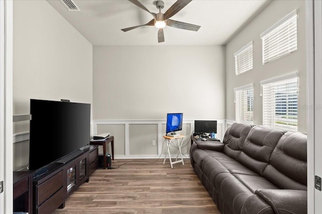 living room featuring ceiling fan and hardwood / wood-style flooring