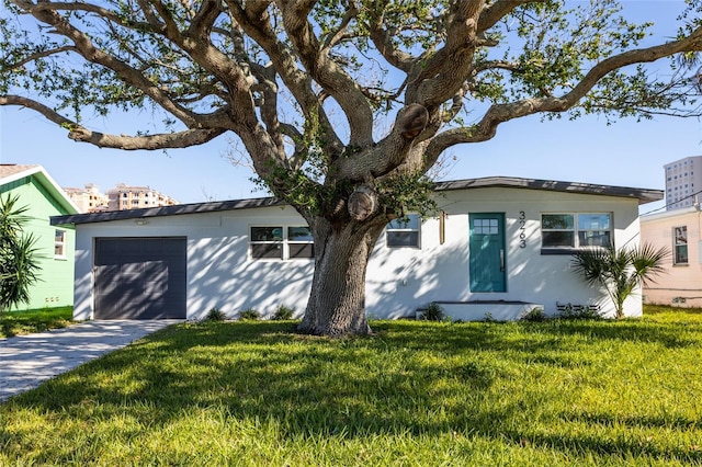 view of front of house with a garage and a front lawn