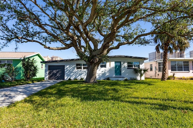 ranch-style home featuring a garage and a front lawn