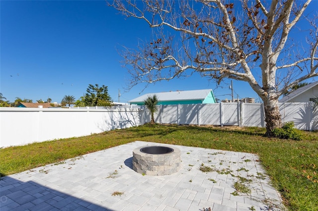 view of yard featuring a patio and an outdoor fire pit