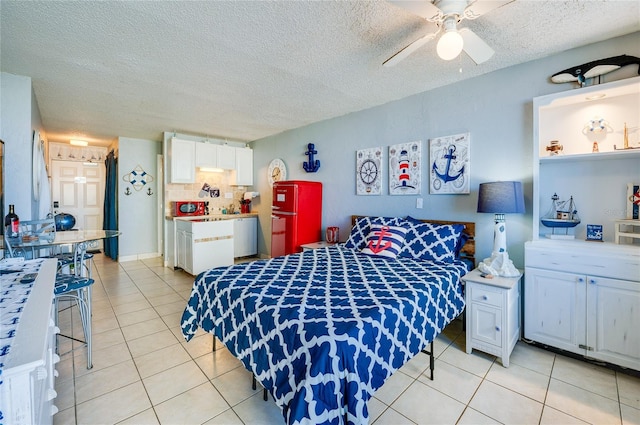 tiled bedroom with ceiling fan and a textured ceiling