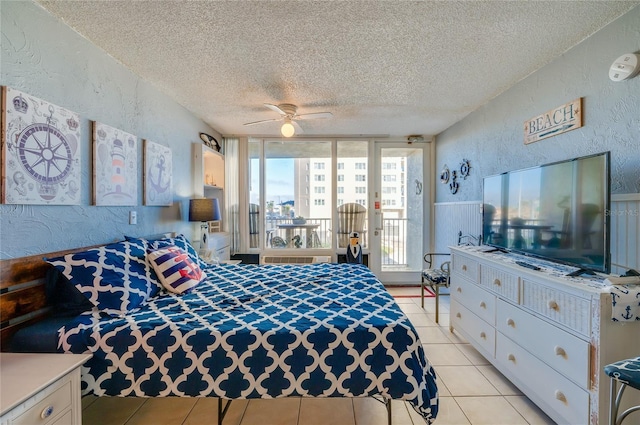 bedroom with access to exterior, a textured ceiling, ceiling fan, and light tile patterned flooring