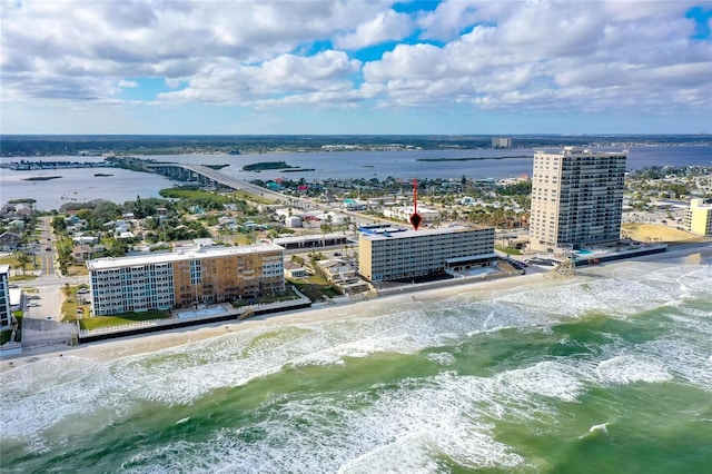 birds eye view of property featuring a water view and a beach view