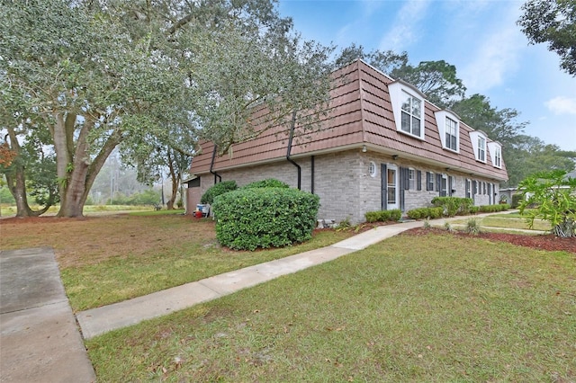 view of side of property with a lawn