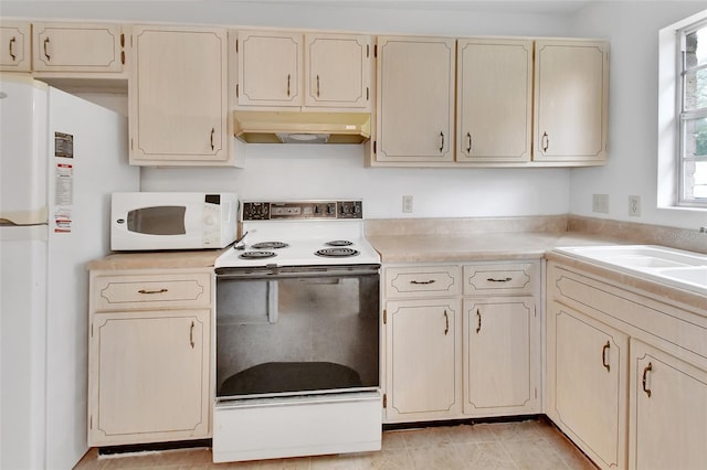 kitchen featuring cream cabinets, white appliances, and sink