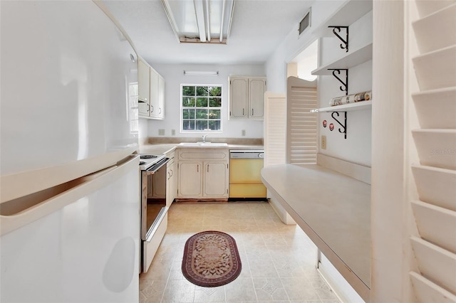 kitchen with stainless steel range with electric stovetop, dishwasher, white fridge, and sink