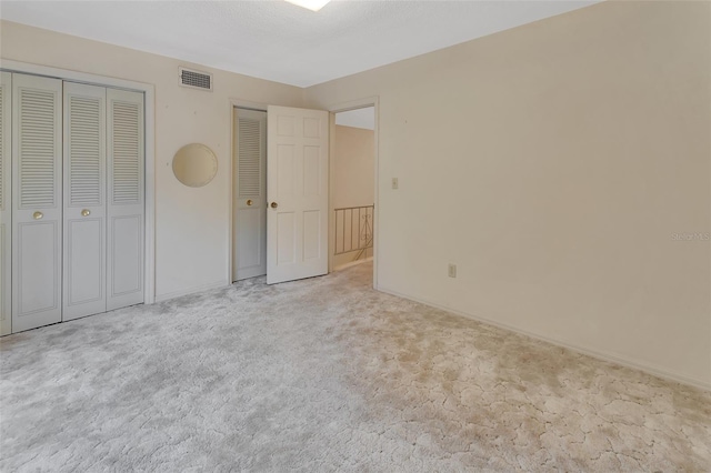 unfurnished bedroom featuring light colored carpet