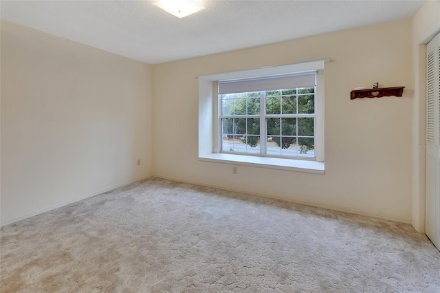 carpeted spare room with a textured ceiling