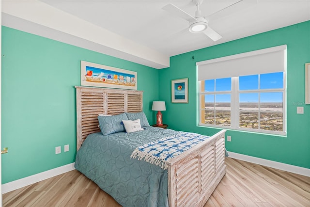 bedroom with ceiling fan and light hardwood / wood-style floors