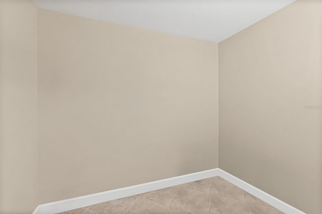 unfurnished room featuring light tile patterned floors