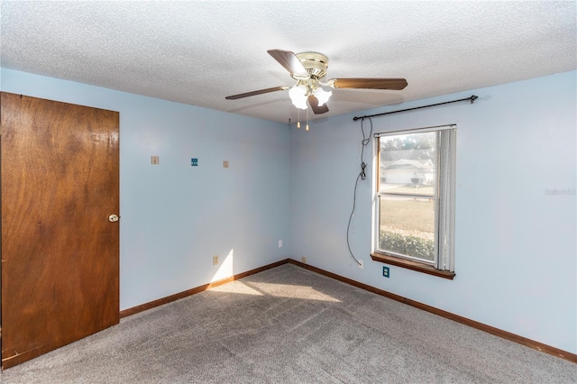 carpeted spare room with ceiling fan and a textured ceiling