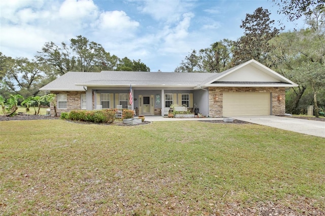 single story home with covered porch, a front yard, and a garage