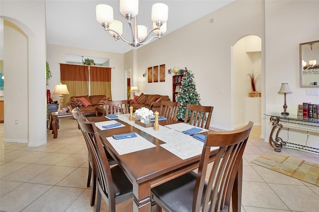 tiled dining room featuring a notable chandelier