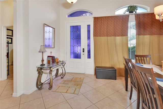 tiled entrance foyer featuring a high ceiling