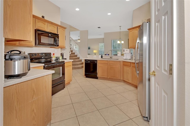 kitchen with pendant lighting, black appliances, light brown cabinets, and sink