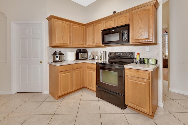 kitchen featuring light tile patterned floors and black appliances