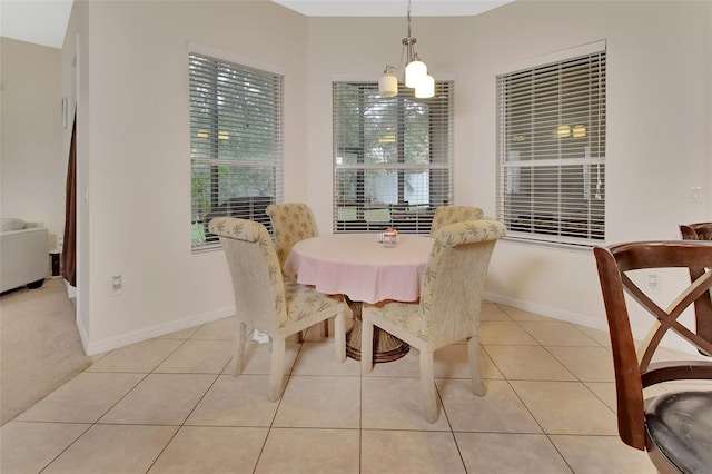 dining space with light tile patterned floors and a chandelier