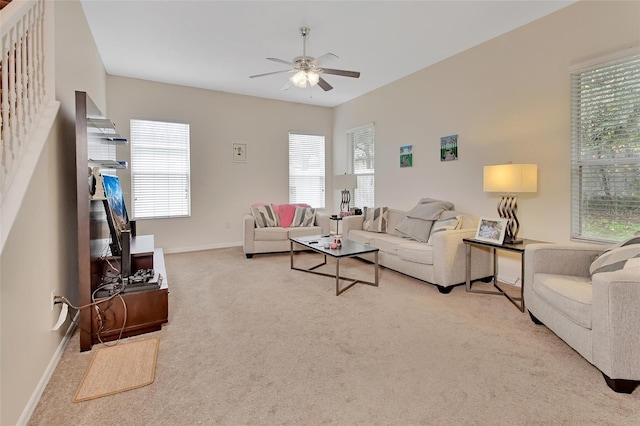 carpeted living room with ceiling fan