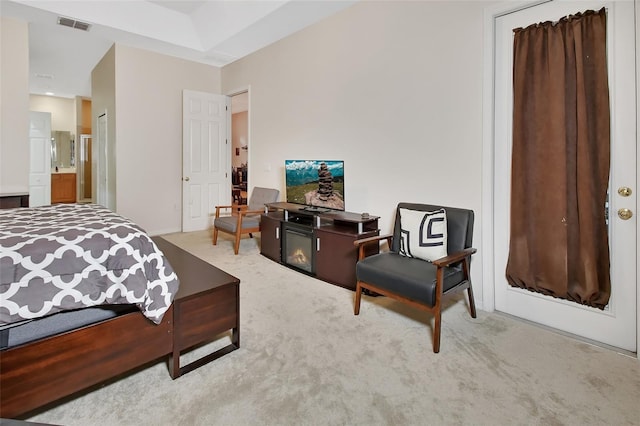 carpeted bedroom featuring ensuite bath