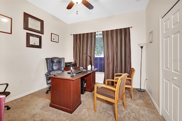 carpeted office featuring ceiling fan