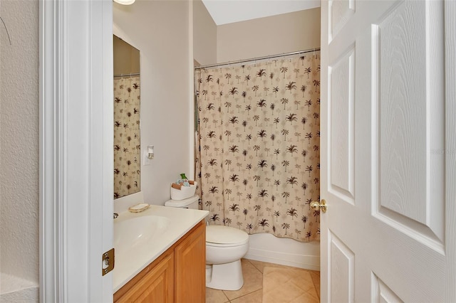 full bathroom featuring tile patterned floors, vanity, toilet, and shower / bath combo with shower curtain