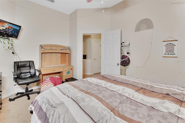 carpeted bedroom featuring a high ceiling