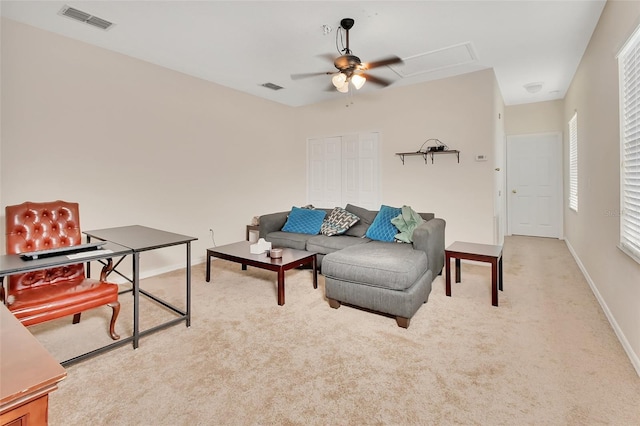 carpeted living room featuring ceiling fan