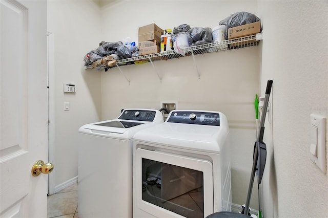 washroom featuring independent washer and dryer and light tile patterned floors