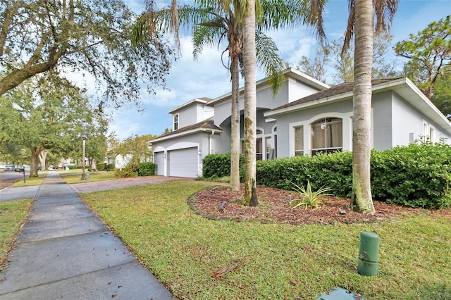 view of front of house featuring a front yard and a garage